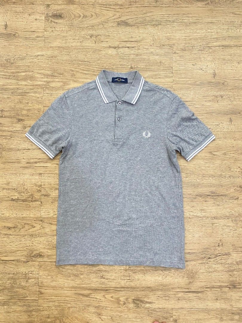 Fred Perry Grey Marl Polo Shirt (Category: Tshirts & Polo Shirts ) located in Cebu City. Submitted by francloset_1 (Listing ID 1453646745, Image 1). Description: - Classic grey marl Fred Perry polo shirt - Iconic embroidered laurel wreath logo on chest - Two-button placket - Ribbed collar and cuffs - Made in China - Ideal for casual wear -Dimes:W17. 5,L25.