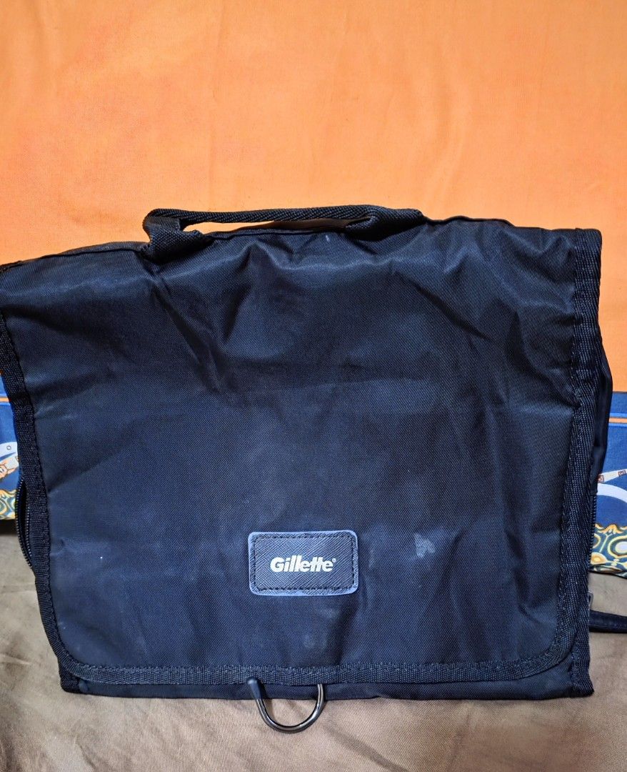 Gillette Black Toiletry Bag Organizer Pouch (Category: Purses & Pouches) located in Calamba. Submitted by ms.declutter13 (Listing ID 1453667120, Image 1). Description: - Brand: Gillette - Color: Black - Features multiple compartments for organization - Includes zippered pockets and mesh sections - Built-in hook for convenient hanging - Ideal for travel or everyday use - Compact and functional design.