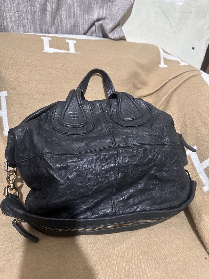 Givenchy Black Leather Nightingale Handbag (Category: Luxury Bags & Wallets) located in Tarlac. Submitted by kishya2024 (Listing ID 1453627962, Image 2). Description: - Genuine black leather Givenchy Nightingale bag - Zipper closure for security - Elegant gold hardware details - Spacious interior, ideal for daily essentials - A timeless and classic piece for any wardrobe -No code -nice in actual.