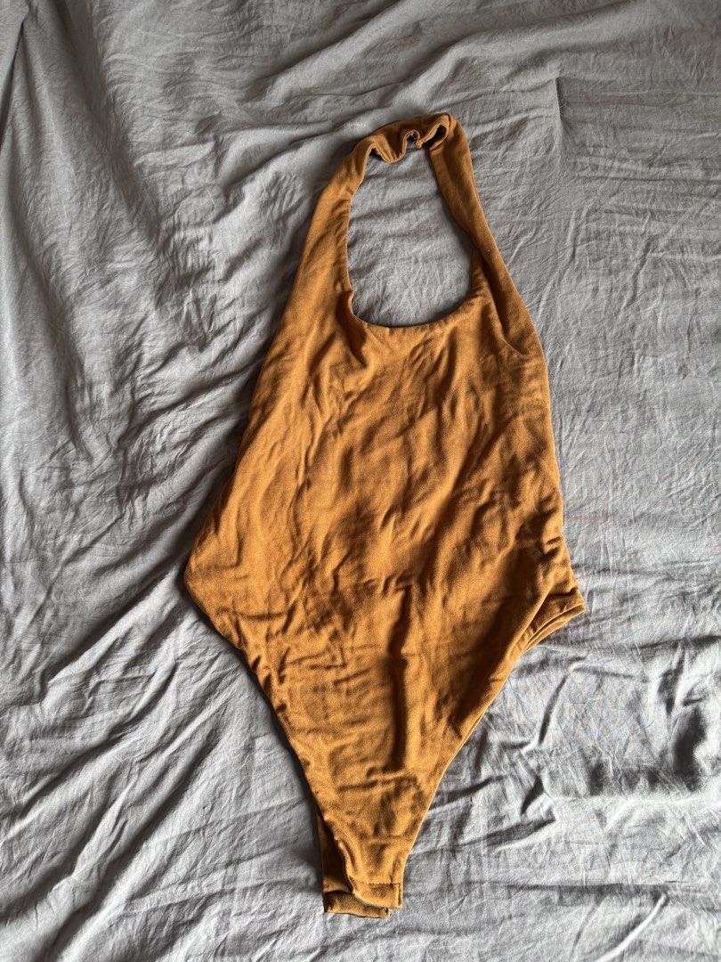 Halter body suit (Category: Sleeveless) located in Manila. Submitted by ls.closet (Listing ID 1453655100, Image 1). Description: - Mustard yellow / brown-ish halter top - Halter body suit - Semi-backless - Perfect for casual wear.