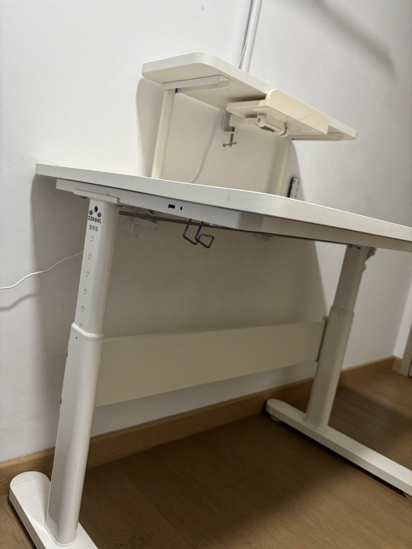 Height Adjustable Study / Computer Desk (Category: Tables & Sets) located in Singapore. Submitted by shonvic (Listing ID 1453629299, Image 2). Description: Selling a height-adjustable study/computer desk in excellent condition. Clean, sturdy, and fully functional. Features: * Manual crank height adjustment (smooth and easy to use) * Spacious white desktop * Removable upper shelf – use it with or without the shelf * Adjustable book/tablet holder *
