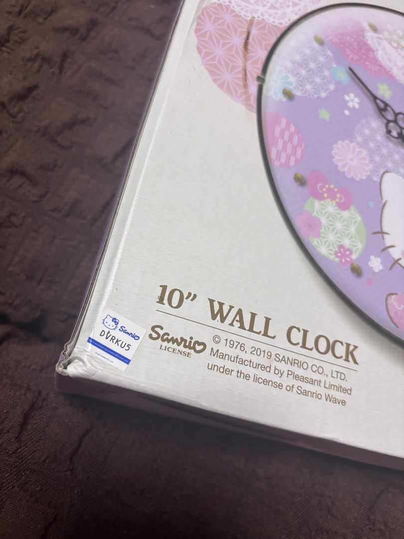 Hello Kitty 10" Wall Clock - Sanrio Licensed (Category: Clocks) located in Quezon City. Submitted by jaedenry0228 (Listing ID 1453631204, Image 2). Description: - Adorable 10-inch Kitty wall clock. - Features a charming purple background with floral and lace details. - Kitty is depicted in a traditional kimono. - Ideal for any Kitty enthusiast's room or as a thoughtful gift. - Requires 1 AA battery (not included). - Manufactured under license by 