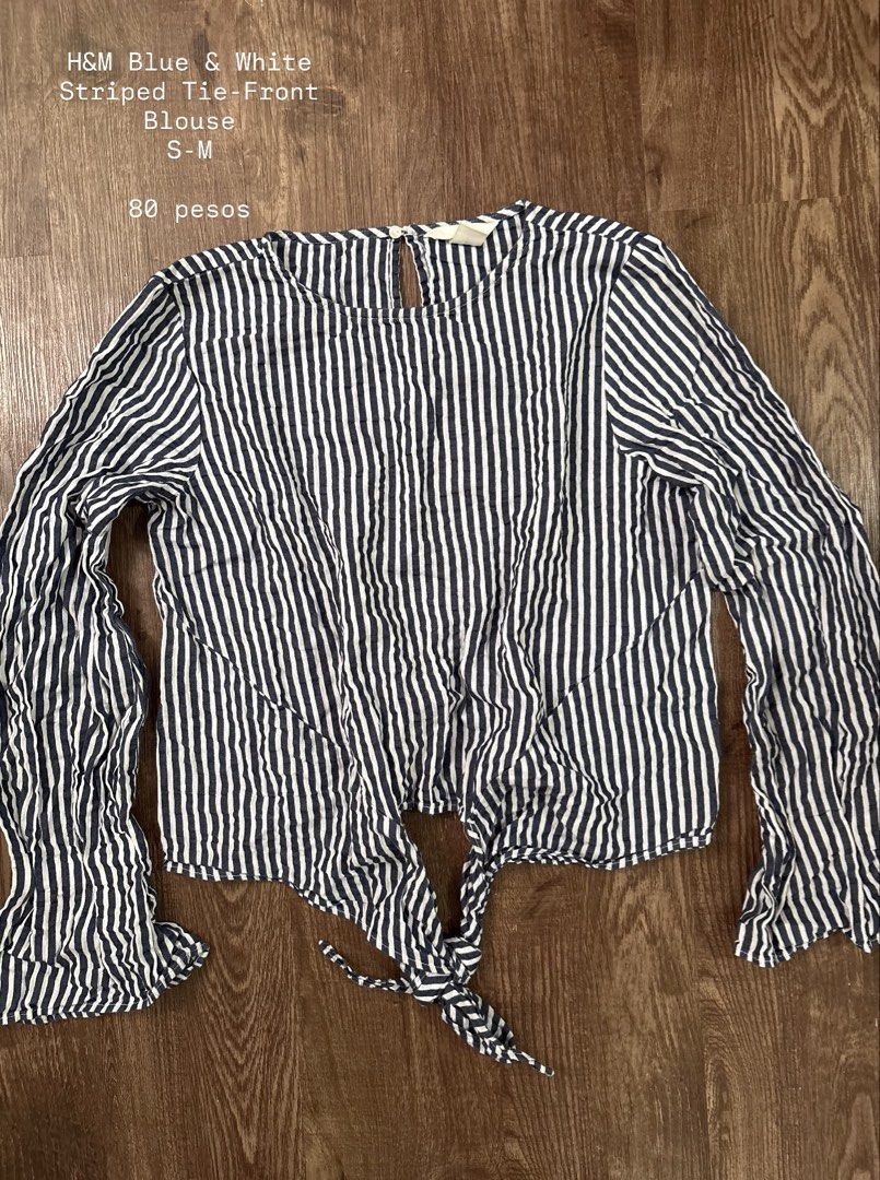 H&M Blue & White Striped Tie-Front Blouse (Category: Blouses) located in Rizal. Submitted by decluttch (Listing ID 1453637277, Image 1). Description: - H&M Blue & White Striped Blouse - Tie-front style - Long bell sleeves - Size: S-M - Textured stripe fabric - Ideal for casual wear - Easy to pair with jeans or shorts.