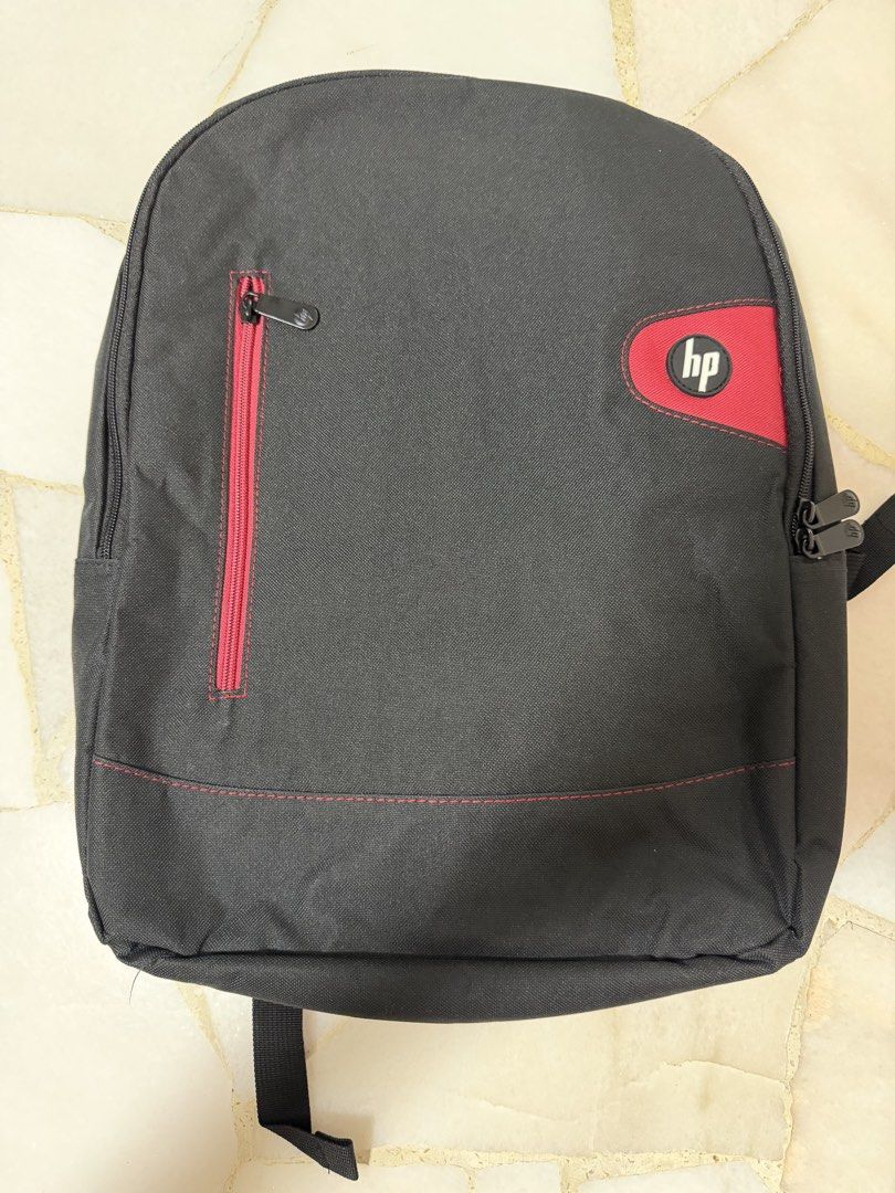 HP Backpack (Category: Backpacks) located in Singapore. Submitted by crazydino__ (Listing ID 1453767136, Image 1). Description: Clean, well-maintained, and perfect for carrying a laptop, books, and other daily essentials. Features: - Padded laptop compartment for added protection - Multiple compartments for easy organization - Comfortable adjustable shoulder straps - Durable and lightweight design - Suitable for work, school, or travel - Conditio