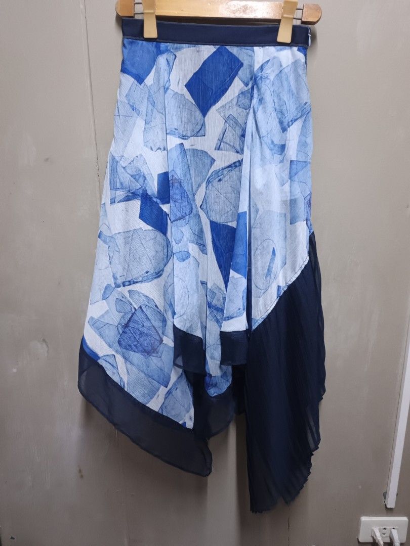 Initial Blue Abstract Print Asymmetrical Pleated Skirt (Category: Skirts) located in Dasmarinas. Submitted by jessicamae43174 (Listing ID 1453701570, Image 1). Description: - Blue and white abstract print skirt from Initial. - Asymmetrical hemline. - Navy pleated chiffon panels on the sides. - Lightweight and flowy fabric. - Perfect for dressing up or down. - Refer to label for material and care instructions..