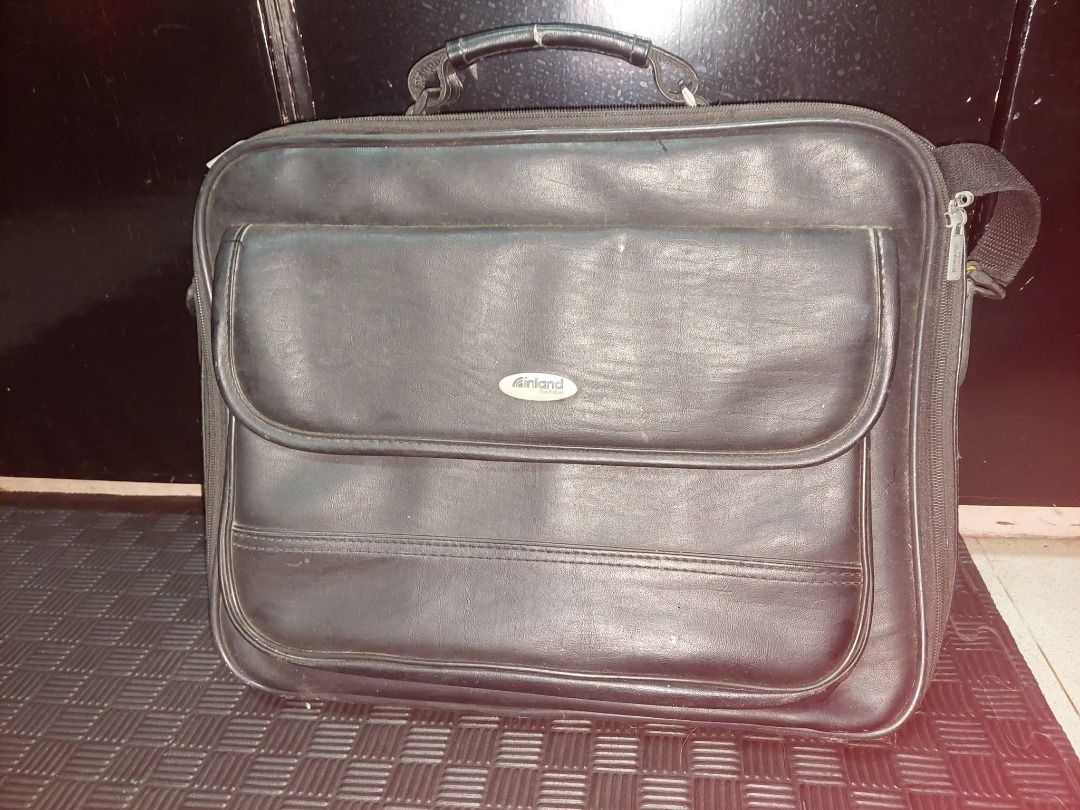 Inland Titan Pro Case (Category: Laptop Bags & Sleeves) located in Pasig City. Submitted by calmdragon (Listing ID 1453758887, Image 1). Description: - Sleek black laptop bag - Faux leather material - Front flap pocket for quick access - Comfortable top handle - Detachable shoulder strap for versatility - Ample interior space for laptop and accessories - Ideal for work or school - All zippers are intact and functional.