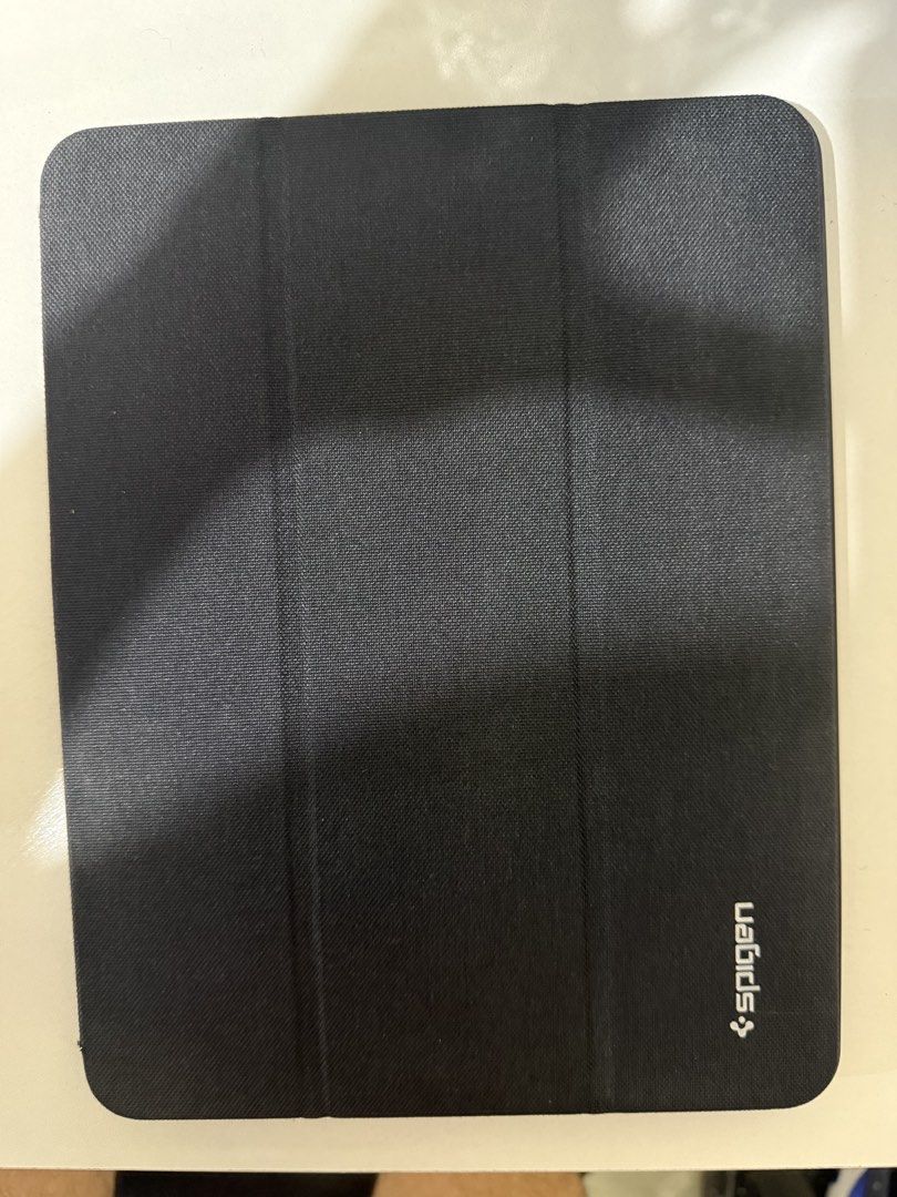 iPad Air Case SPIGEN (Category: Cases & Sleeves) located in Manila. Submitted by CB2023 (Listing ID 1453733306, Image 1). Description: The case is compatible with the latest iPad Air (8th generation), although it was originally released for the 7th generation. I never actually used it because of my Apple Pencil. The pencil holder is located on the opposite side, away from the magnetic charging area, making it inconvenient to charge the Apple Penc