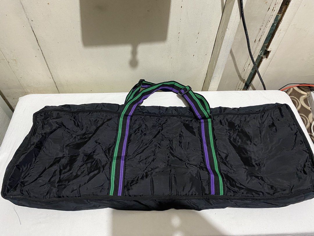 KBC Dynatone HS-000 Keyboard Gig Bag (Category: Musical Instruments) located in Manila. Submitted by resi.diaz (Listing ID 1453780287, Image 2). Description: - Approx: 103 x 35 x 11 cm - Black gig bag designed for keyboards. - Features stylish purple and green stripe accents on handles and trim. - Prominently displays the KBC Dynatone HS-000 logo on the front. - Offers ample interior space to comfortably fit your keyboard. - Secure zip closure en