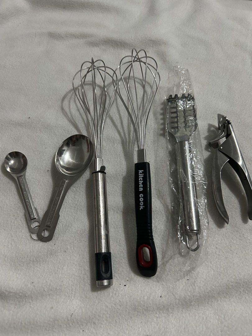 Kitchen Utensils Set - Whisks, Measuring Spoons, Garlic Press (Category: Cookware & Accessories) located in Angeles City. Submitted by kimkant06043026 (Listing ID 1453622838, Image 1). Description: - Complete kitchen tool set for all your cooking and baking needs. - Includes two durable metal whisks, one featuring a 'kitchen cook' black handle. - Set of measuring spoons for accurate ingredient portions. - Sturdy metal garlic press for easy prep. 