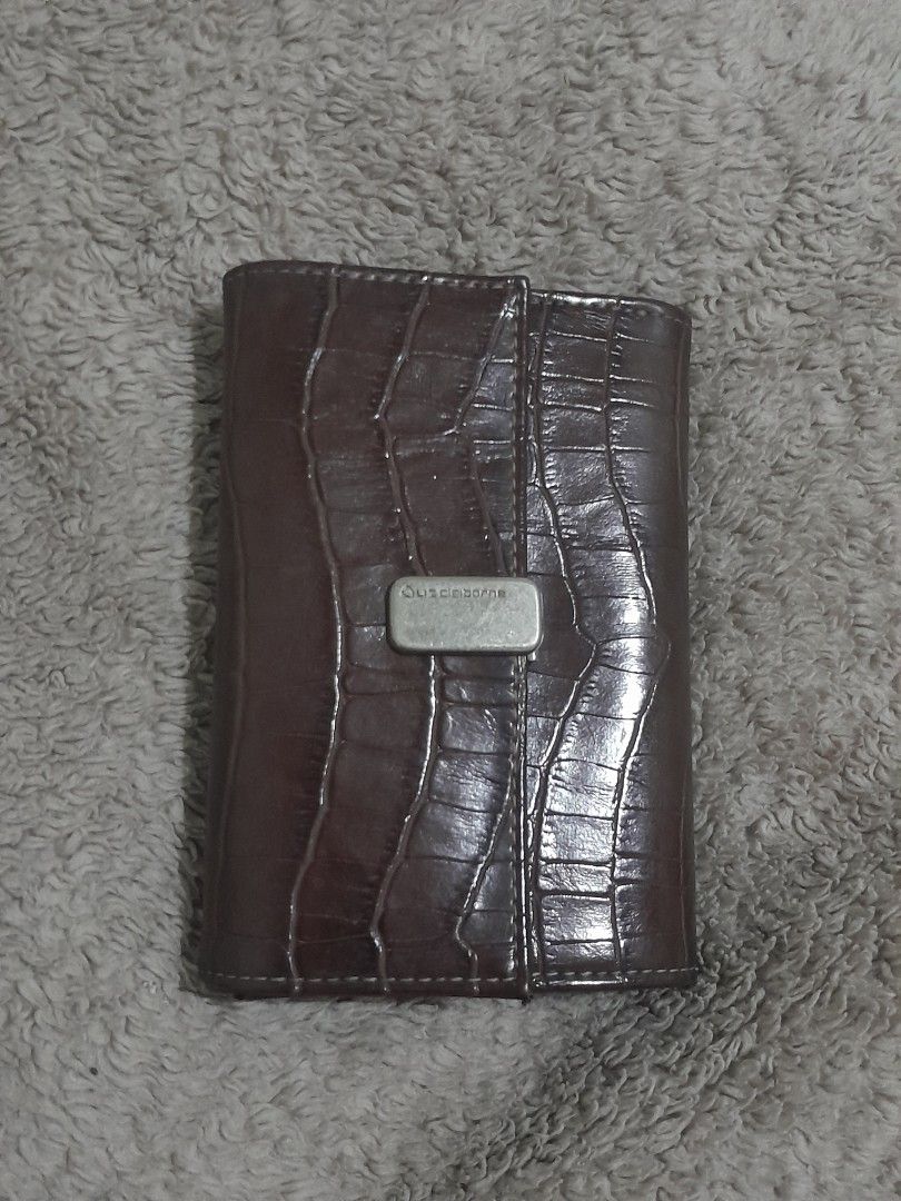 Liz Claiborne Brown Croc Trifold Wallet (Category: Wallets & Card holders) located in Pasig City. Submitted by miffych (Listing ID 1453735264, Image 1). Description: • can fit at least 14–16 cards • slightly nego for sure buyers only • can send more pics, js send a message • slight issue: needs cleaning and may scratches sa metallic logo clasp (see 2nd slide) • rfs: nakatambak lang.