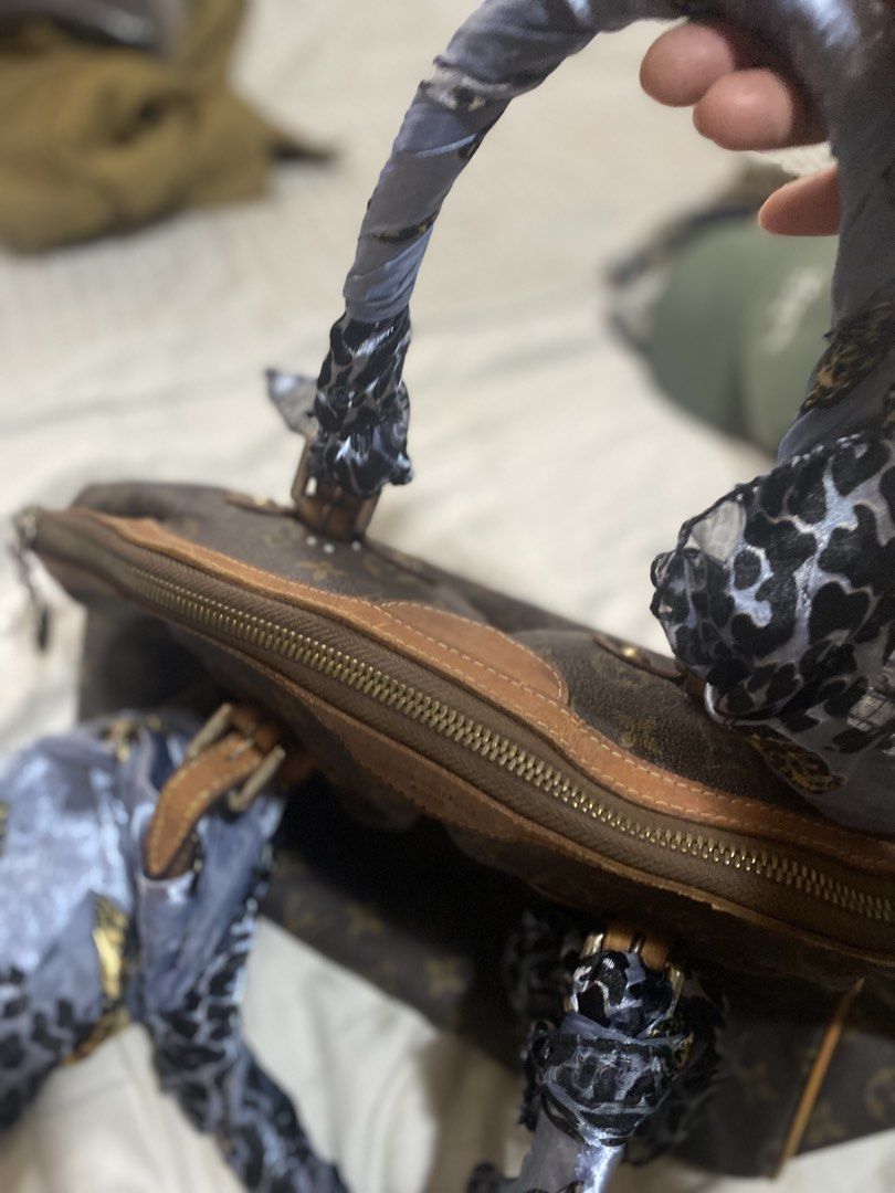 Louis Vuitton Monogram Speedy Bag with Scarf Accent (Category: Luxury Bags & Wallets) located in Santa Rosa. Submitted by intra_life4life (Listing ID 1453678612, Image 2). Description: - Iconic Louis Vuitton Speedy bag - Classic monogram canvas - Leather trim shows some wear - Handles adorned with a cute patterned scarf - Smooth zipper closure - Timeless piece, perfect for everyday use.