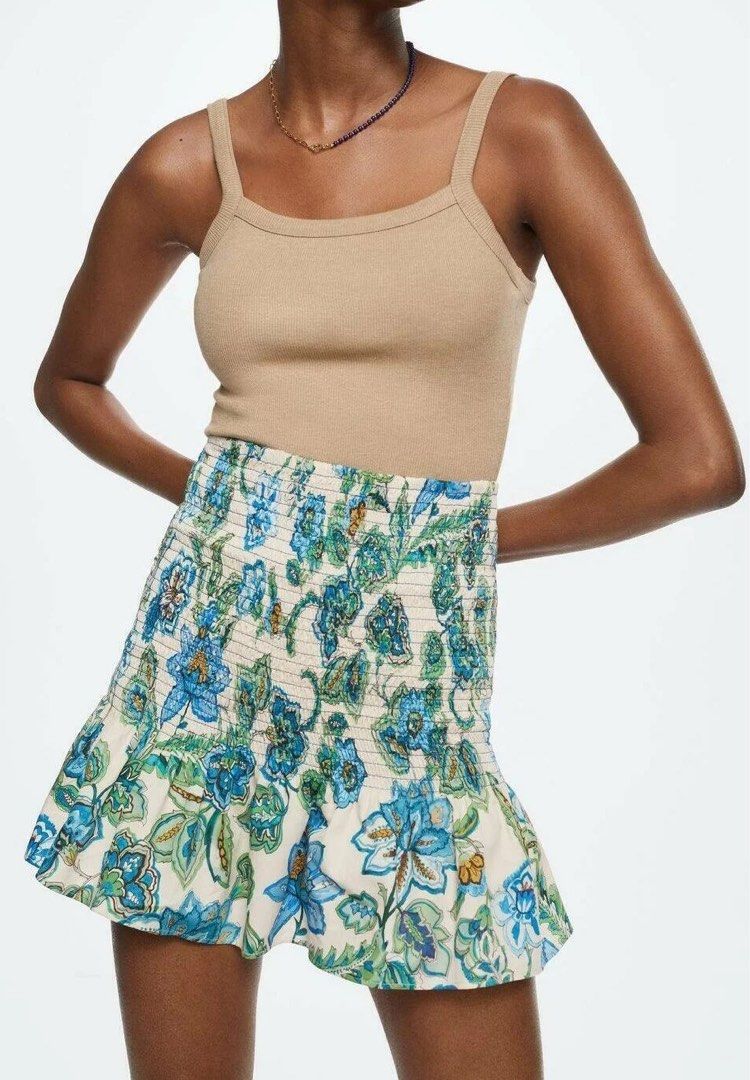 Mango Smocked Printed Skirt (Category: Skirts) located in Rizal. Submitted by okcath (Listing ID 1453778533, Image 2). Description: - Cream colored mini skirt - Blue and green floral print - Comfortable smocked waistband - Playful ruffled hemline - Ideal for summer outfits - Pairs well with tanks or tees.