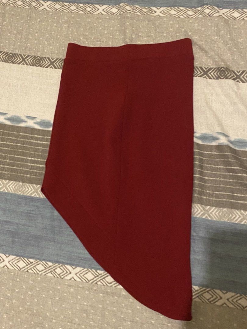 Maroon Asymmetrical Hem Midi Skirt (Category: Skirts) located in Tanauan. Submitted by rie098 (Listing ID 1453734165, Image 2). Description: - Deep maroon midi skirt - Unique asymmetrical hemline - Subtle fabric texture - Comfortable pull-on style with elastic waistband - Perfect for dressing up or down - Pairs well with heels or flats.