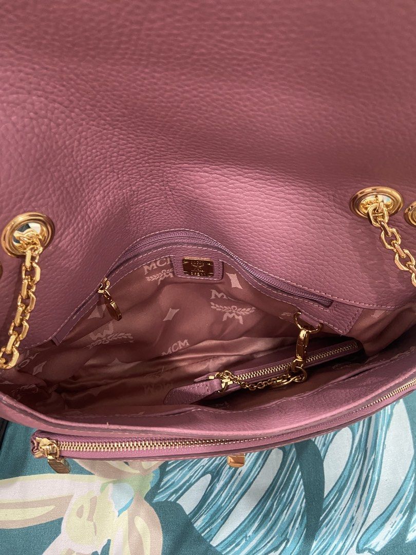 MCM Pink Leather Chain Shoulder Bag (Category: Luxury Bags & Wallets) located in Quezon City. Submitted by emjen (Listing ID 1453656892, Image 3). Description: - Authentic MCM bag in a lovely pink shade. - Features a stylish gold chain strap. - Signature MCM logo details for a classic look. - Interior lined with MCM branded fabric. - Multiple compartments, including a zippered pocket, for organization. - Secure flap closure with a gold clasp. - V