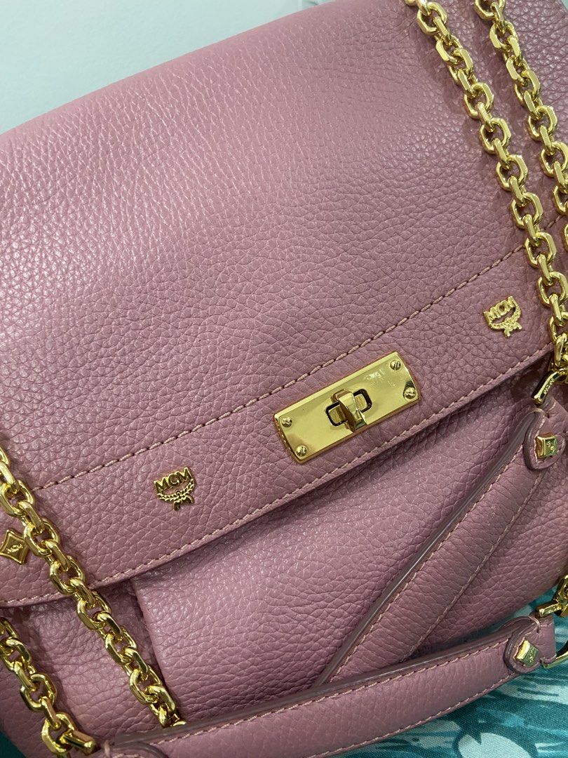 MCM Pink Leather Chain Shoulder Bag (Category: Luxury Bags & Wallets) located in Quezon City. Submitted by emjen (Listing ID 1453656892, Image 2). Description: - Authentic MCM bag in a lovely pink shade. - Features a stylish gold chain strap. - Signature MCM logo details for a classic look. - Interior lined with MCM branded fabric. - Multiple compartments, including a zippered pocket, for organization. - Secure flap closure with a gold clasp. - V