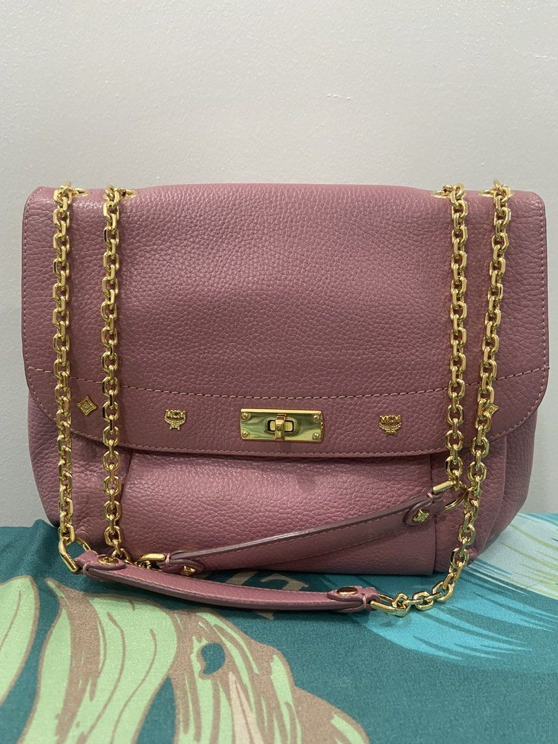 MCM Pink Leather Chain Shoulder Bag (Category: Luxury Bags & Wallets) located in Quezon City. Submitted by emjen (Listing ID 1453656892, Image 1). Description: - Authentic MCM bag in a lovely pink shade. - Features a stylish gold chain strap. - Signature MCM logo details for a classic look. - Interior lined with MCM branded fabric. - Multiple compartments, including a zippered pocket, for organization. - Secure flap closure with a gold clasp. - V