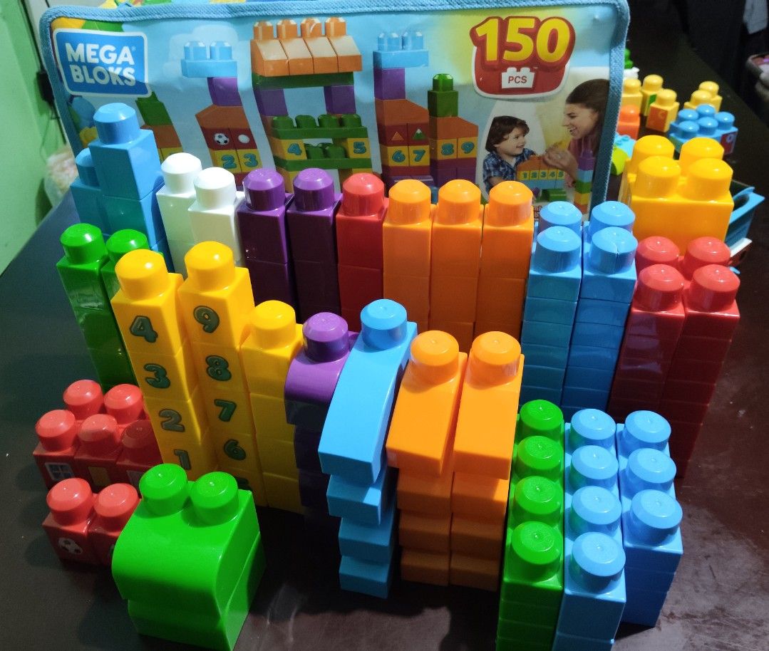 Mega Bloks 150 Pieces Building Blocks Set (Category: Lego & Building Sets) located in Paranaque City. Submitted by ca.firstonlinebiz (Listing ID 1453642623, Image 1). Description: - Mega Bloks building blocks set - 150 pieces included - Assorted vibrant colors: blue, green, yellow, orange, purple, red - Some blocks feature number prints - Encourages creative play and building skills - Convenient storage bag included - Hours of fun for children.