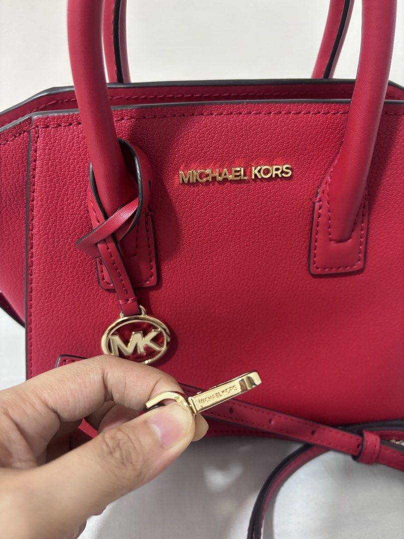 Michael Kors Red Leather Satchel Handbag (Category: Luxury Bags & Wallets) located in Quezon City. Submitted by makeitkmn (Listing ID 1453735654, Image 2). Description: - Authentic Michael Kors red leather satchel - Elegant gold hardware details - Iconic MK logo charm - Secure lock with key included - Versatile top handles and detachable shoulder strap - Ample interior space for all your essentials - Ideal for everyday use.