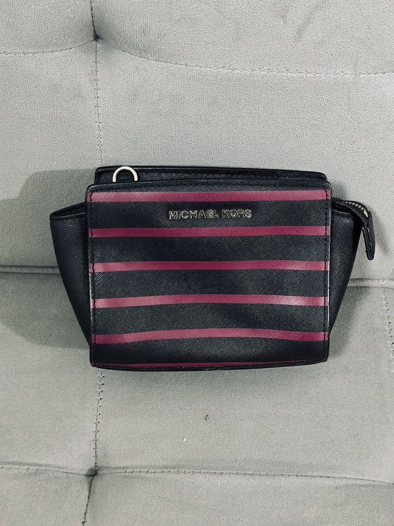 Michael Kors Striped Wallet Pouch (Category: Luxury Bags & Wallets) located in Tarlac. Submitted by via_banana (Listing ID 1453768876, Image 1). Description: - Authentic Michael Kors wallet pouch - Stylish black and maroon stripe design - Secure zippered compartment - Interior card slots for organization - Compact and perfect for essentials - Convenient D-ring attachment on the side - Interior is clean and well-maintained.