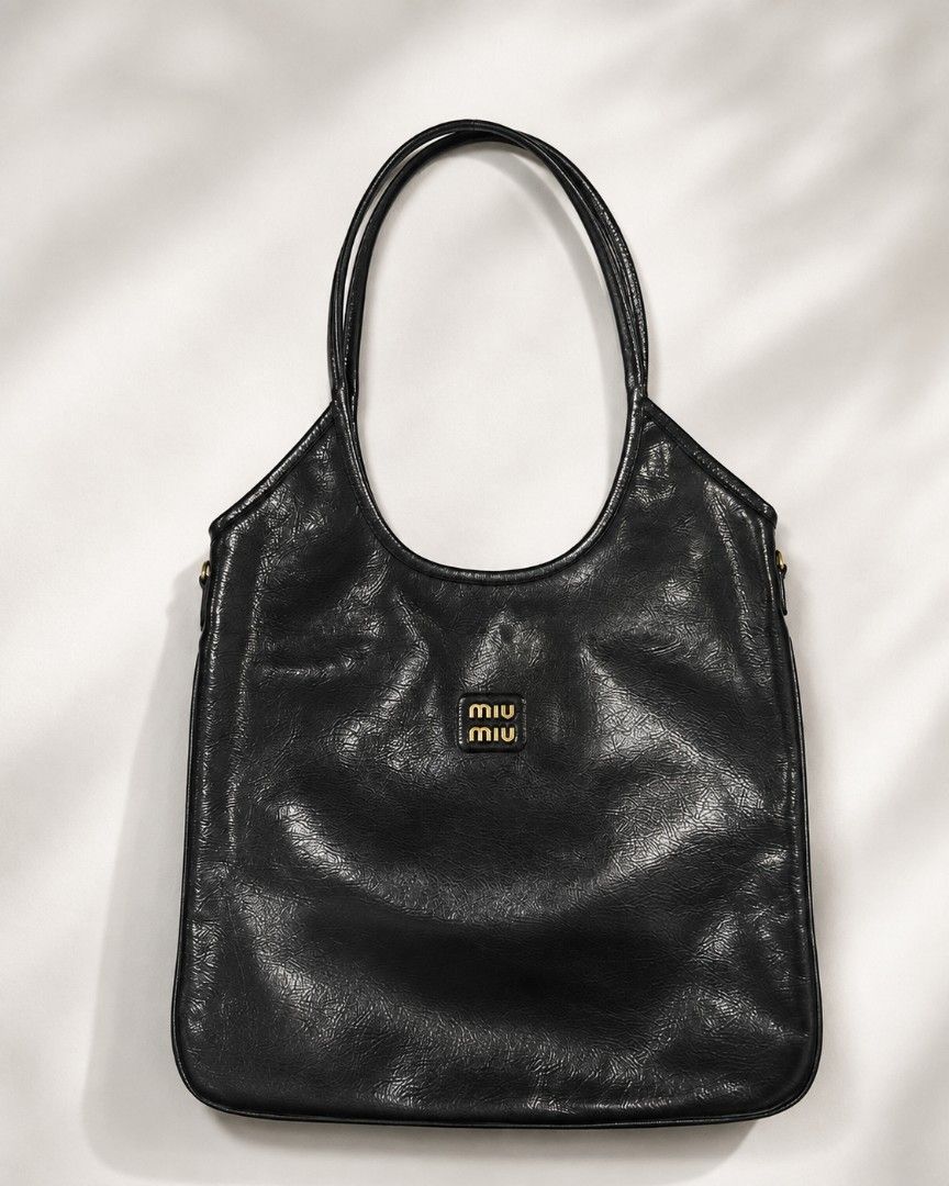 Miu Miu Ivy Tote bag (Category: Luxury Bags & Wallets) located in Pateros City. Submitted by hoarderhub (Listing ID 1453803473, Image 1). Description: Miu Miu Ivy Tote bag Black Patent leather with black canvas lining and gold hardware My favorite work bag. Used only around 5x. It's understated, timeless, and very classy. ✨ Please make an offer. Once accepted, I'll share my complete pickup details (name, address, and contact number) for your peac