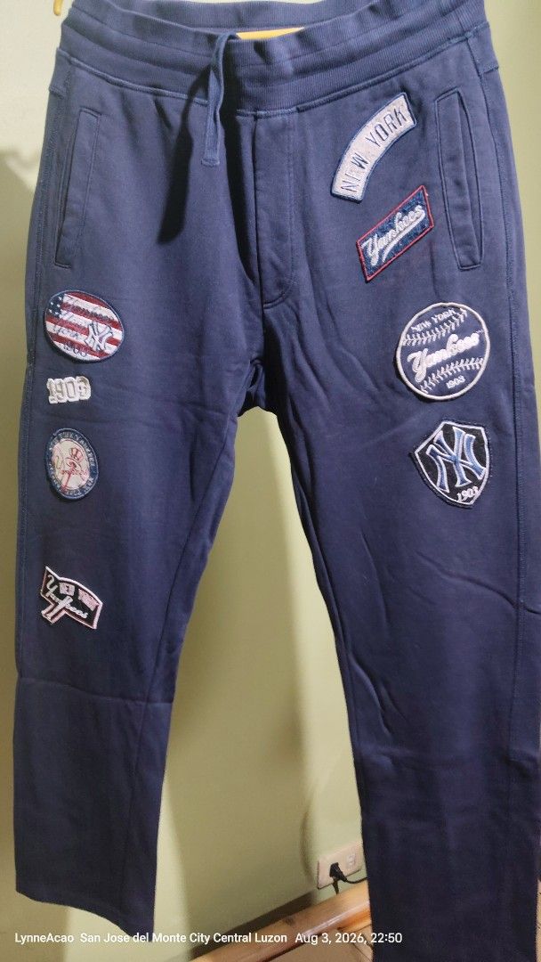 MLB New York Yankees Patched Sweatpants Size 32 (Category: Joggers) located in Manila. Submitted by rhobin.m08 (Listing ID 1453622749, Image 1). Description: - Navy blue sweatpants - Size 32 - All-over New York Yankees patches - Yankees logo on back pocket - 'Yankees' script down the leg - Comfortable cotton blend fabric - Ideal for casual wear and showing team spirit.