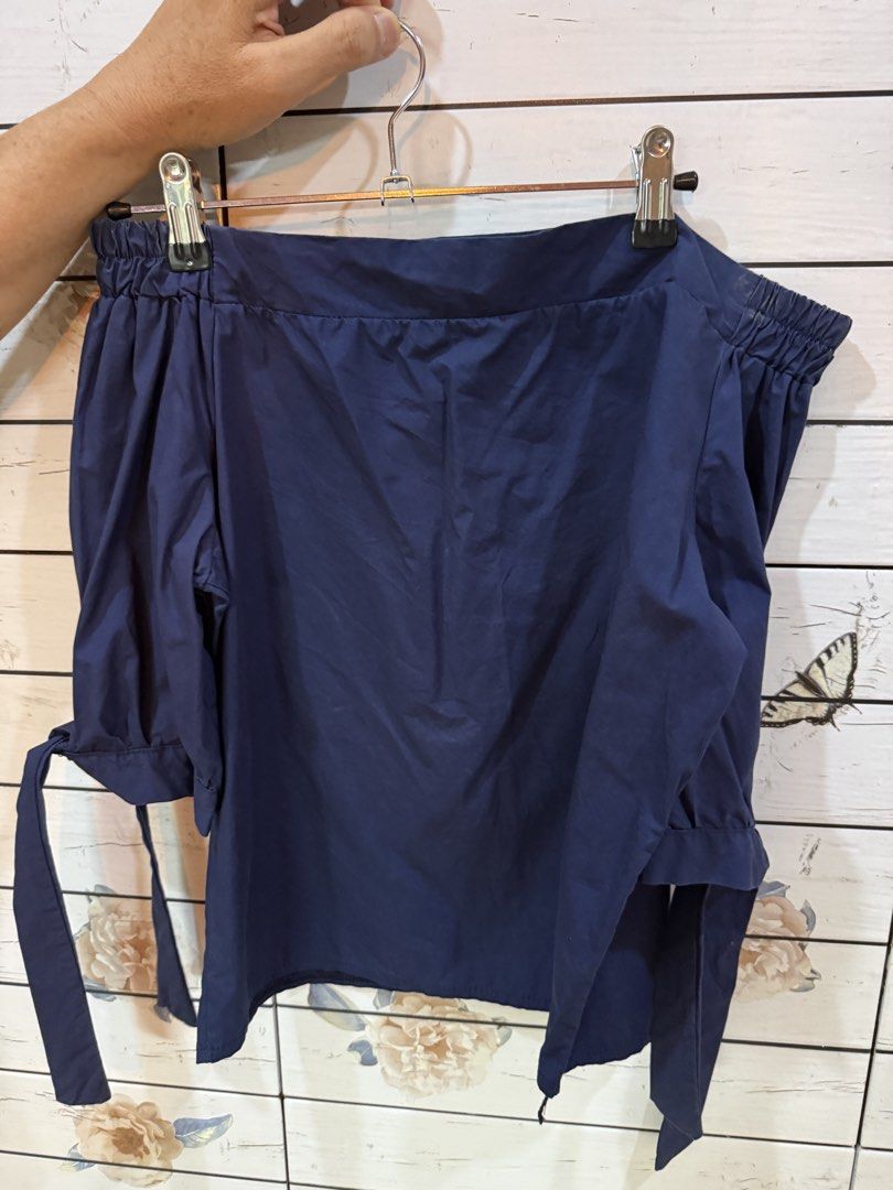 Navy Blue Off-Shoulder Top with Tie Sleeves (Category: Blouses) located in Imus. Submitted by ayessa_chloe (Listing ID 1453684377, Image 2). Description: - Chic navy blue off-shoulder top - Comfortable elasticated neckline - Trendy puff sleeves with tie details at cuffs - Perfect for both casual outings and dressed-up events - Effortlessly easy to style.