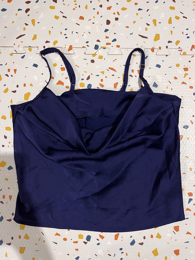 Navy Blue Satin Cowl Neck Cami Top (Category: Sleeveless) located in Pasig City. Submitted by thedngsthings (Listing ID 1453786793, Image 1). Description: - Navy blue satin cami top - Features a cowl neckline - Adjustable spaghetti straps - Fabric has a beautiful sheen - Perfect for dressing up or down - Pairs well with jeans or skirts.