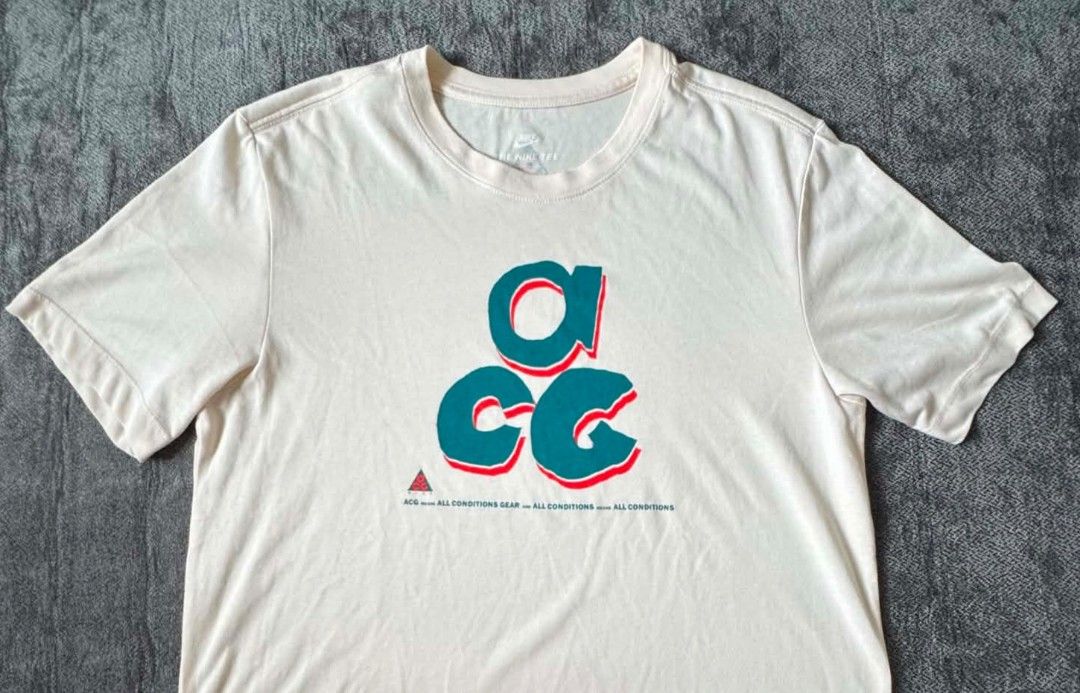 Nike ACG T-Shirt Cream (Category: Tshirts & Polo Shirts ) located in Caloocan City. Submitted by jpygoodies (Listing ID 1453703084, Image 1). Description: - Cream colored Nike ACG t-shirt - Features the iconic ACG logo graphic on the front - Small ACG logo detail on the back - "All Conditions Gear" (ACG) collection - Comfortable and versatile for everyday wear.