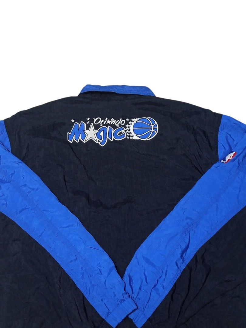 Nike Orlando Magic NBA Jacket (Category: Coats, Jackets and Outerwear) located in Manila. Submitted by rossable (Listing ID 1453712464, Image 2). Description: - Vintage Nike jacket - Features Orlando Magic logo on back - Black and blue colorway - Zip-up front with snap button closure - Drawstrings at the hem - Ideal for basketball fans and collectors.