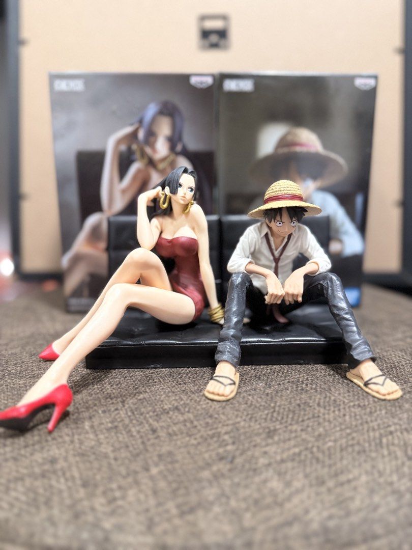 One Piece Boa Hancock & Monkey D. Luffy Figures (Category: Figurines & Statues) located in Manila. Submitted by jepandan (Listing ID 1453747153, Image 1). Description: - Set includes One Piece figures of Boa Hancock and Monkey D. Luffy. - Figures are posed sitting on a black couch. - Original boxes are visible in the background. - Ideal addition to any One Piece fan's collection..