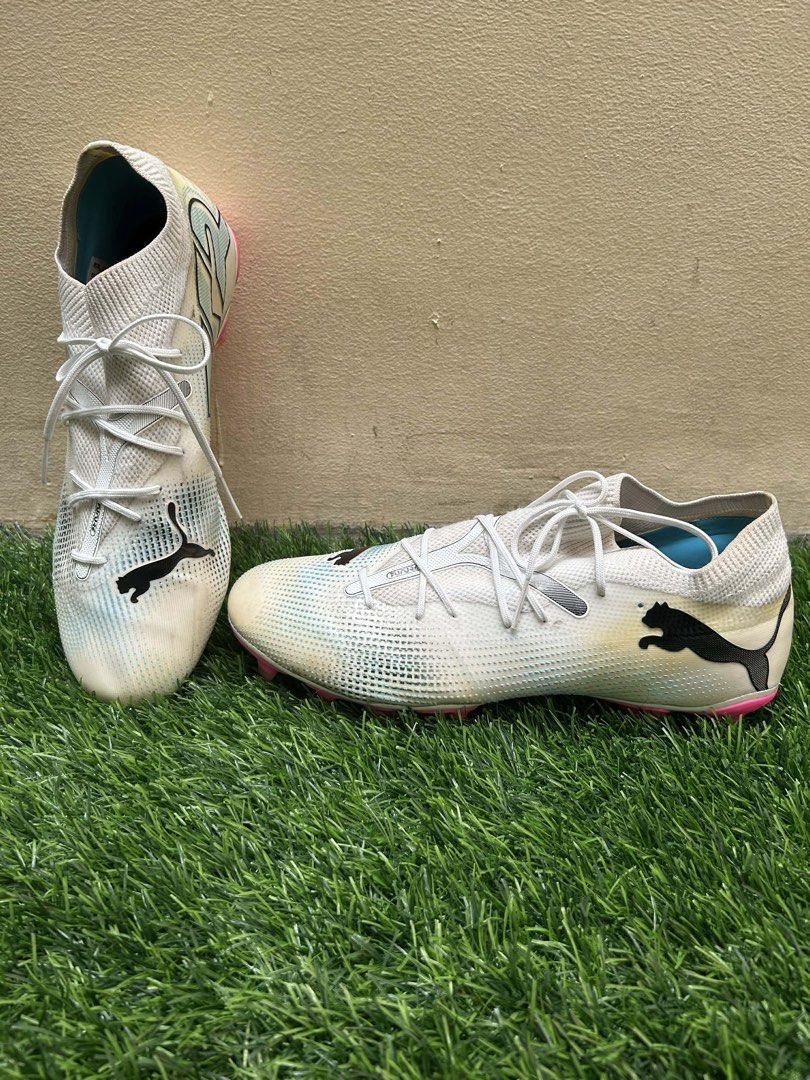 Puma Future 7 Match AG/FG (Category: Boots) located in Quezon City. Submitted by pur6ing (Listing ID 1453812893, Image 1). Description: OPEN FOR NEGO! - Puma Future 7 Match AG/FG - Color: White with pink and blue accents - Size: US 11, UK 10, 44.5 EUR, 29 CM - Closure: Lace-up - Ideal for: Firm ground & artificial ground play - Condition: Still good RFS: Buying for new boots.