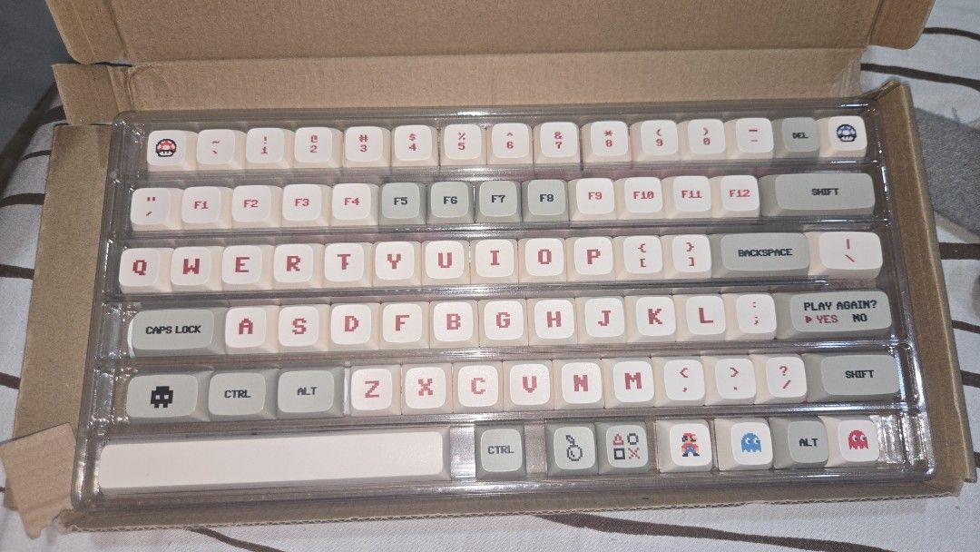 Retro Gaming Themed Keycap Set for Mechanical Keyboard (Category: Computer Keyboard) located in Las Pinas. Submitted by shesmywinina (Listing ID 1453680694, Image 1). Description: - Relive classic gaming with retro pixel art keycaps (Mario, Pac-Man, etc.) - Complete set including alphanumeric, function, and modifier keys - Elevate your mechanical keyboard's look - Please note: This is for keycaps only, not a full keyboard - Comes neatly organized