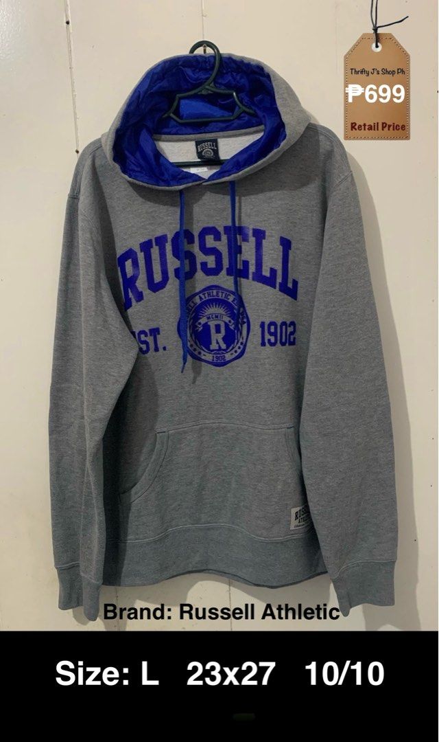 Russell Athletic Grey Hoodie Size L (Category: Hoodies) located in Santa Rosa. Submitted by thriftyjs (Listing ID 1453717611, Image 1). Description: - Grey Russell Athletic hoodie - Blue accents - Russell Athletic logo and 'Est. 1902' graphic on front - Front pocket - Drawstring hood - Measurements: 23" (width) x 27" (length) - Ideal for casual wear.