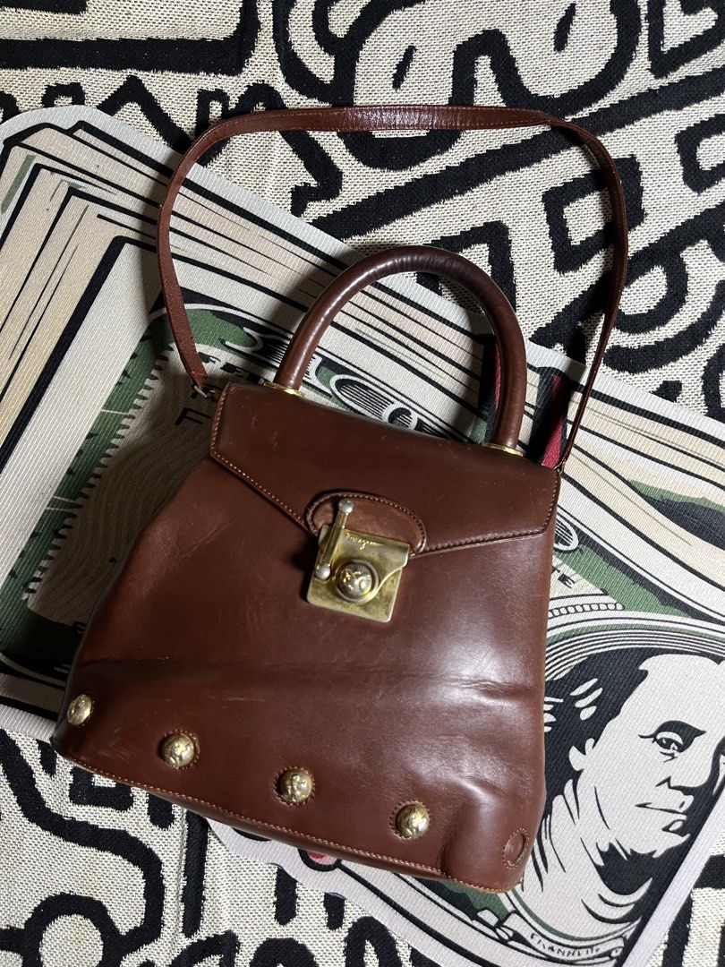 Salvatore Ferragamo Brown Leather Top Handle Bag (Category: Luxury Bags & Wallets) located in Silang. Submitted by yusthrift (Listing ID 1453701822, Image 1). Description: - Vintage Salvatore Ferragamo handbag - Rich brown leather - Iconic Gancini clasp closure - Top handle - Detachable shoulder strap - Signs of wear on leather and hardware (consistent with age) - Classic collectible piece.