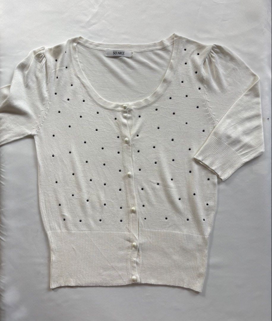 SO NICE White Embellished Button Up Cardigan Size M (Category: Coats, Jackets and Outerwear) located in Iloilo. Submitted by iconicangie (Listing ID 1453788037, Image 1). Description: - Brand: SO NICE - Color: White - Size: M - Neckline: Round - Closure: Button-up front with pearl-like buttons - Embellishments: Scattered black details all over - Sleeves: Three-quarter length with slight shoulder puff - Hem & Cuffs: Ribbed.