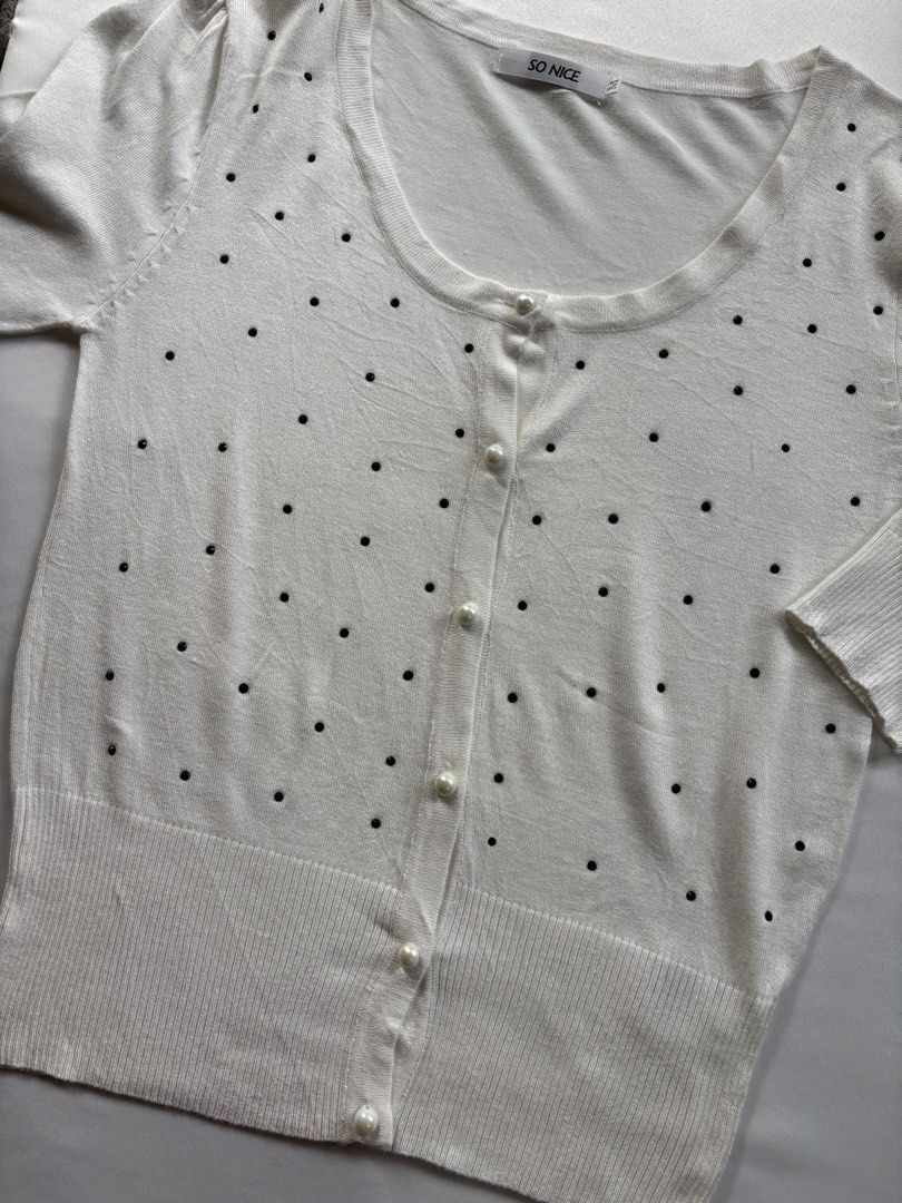 SO NICE White Embellished Button Up Cardigan Size M (Category: Coats, Jackets and Outerwear) located in Iloilo. Submitted by iconicangie (Listing ID 1453788037, Image 2). Description: - Brand: SO NICE - Color: White - Size: M - Neckline: Round - Closure: Button-up front with pearl-like buttons - Embellishments: Scattered black details all over - Sleeves: Three-quarter length with slight shoulder puff - Hem & Cuffs: Ribbed.