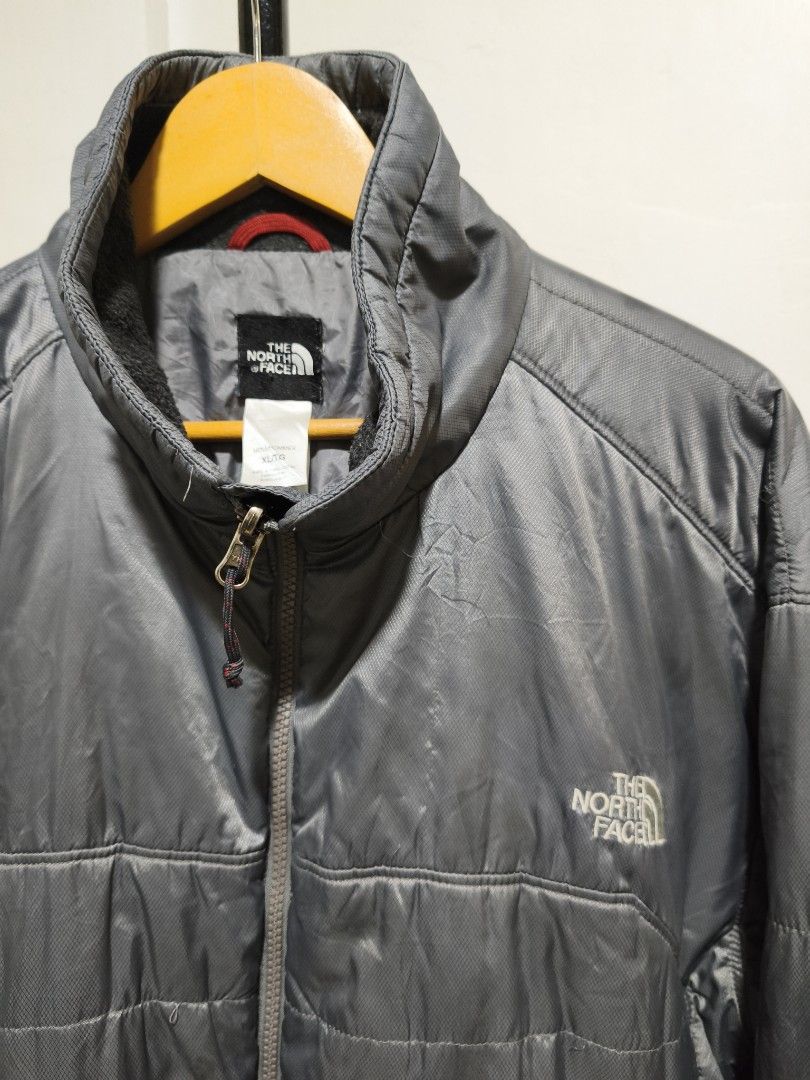 The North Face Puffer Jacket XL Grey (Category: Coats, Jackets and Outerwear) located in Iloilo. Submitted by daddy_declutter (Listing ID 1453797330, Image 2). Description: Length - 29 inches Width - 26 inches Issues: Please see last 2 pictures - Brand: The North Face - Color: Grey - Style: Puffer Jacket - Features: Full zip front, stand-up collar, quilted design for warmth - Details: Logo on chest and back - Material: 100% Polyester (Shell, Lini