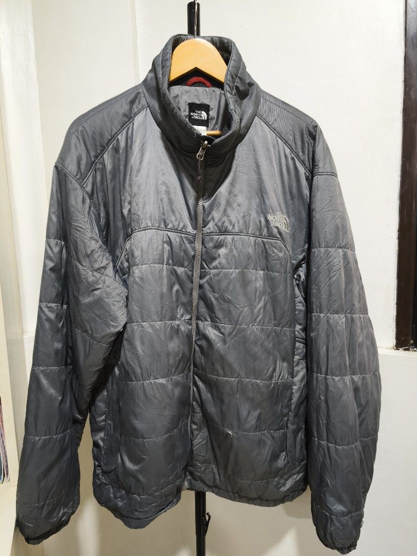 The North Face Puffer Jacket XL Grey (Category: Coats, Jackets and Outerwear) located in Iloilo. Submitted by daddy_declutter (Listing ID 1453797330, Image 1). Description: Length - 29 inches Width - 26 inches Issues: Please see last 2 pictures - Brand: The North Face - Color: Grey - Style: Puffer Jacket - Features: Full zip front, stand-up collar, quilted design for warmth - Details: Logo on chest and back - Material: 100% Polyester (Shell, Lini
