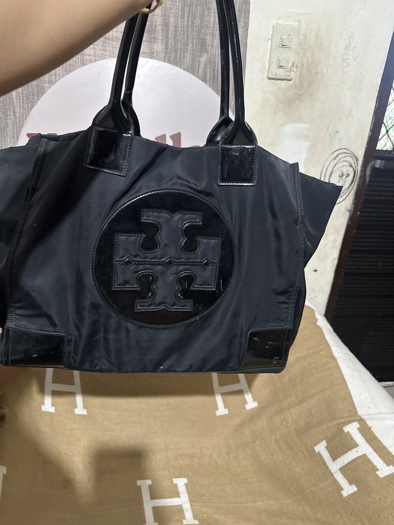 Authentic Tory Burch Black Nylon Tote Bag (Category: Luxury Bags & Wallets) located in Tarlac. Submitted by kishya2024 (Listing ID 1453667724, Image 2). Description: - Authentic Tory Burch tote bag in black. - Durable nylon material with elegant leather trim. - Signature Tory Burch logo prominently displayed on the front. - Secure magnetic snap closure. - Convenient interior zip pocket for essentials. - Ample space, ideal for everyday errands or 
