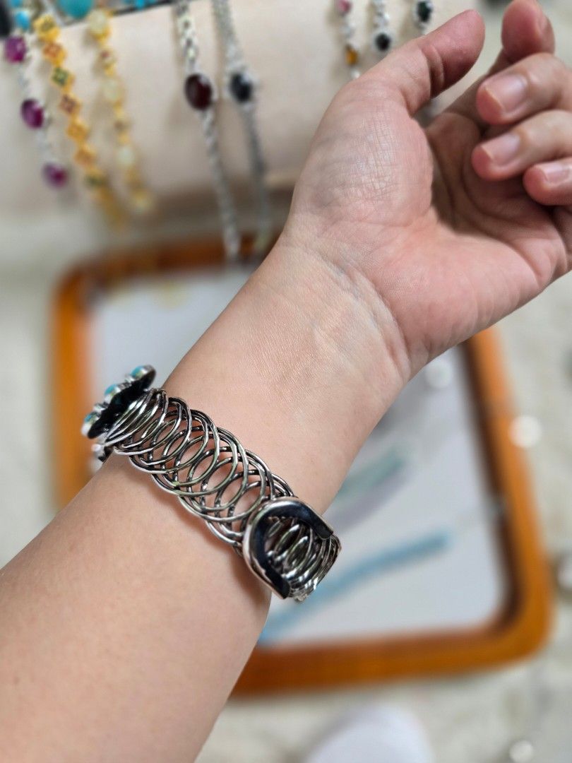 Turquoise Cuff Bracelet with Silver Tone Metal (Category: Bracelets) located in Santa Rosa. Submitted by crystal1.0 (Listing ID 1453759392, Image 2). Description: - Statement cuff bracelet - Features a large central turquoise stone - Accented with smaller turquoise stones - Intricate silver-toned metal design - Adjustable - Coiled metal band at the back - Unique piece for adding a pop of color to any outfit.