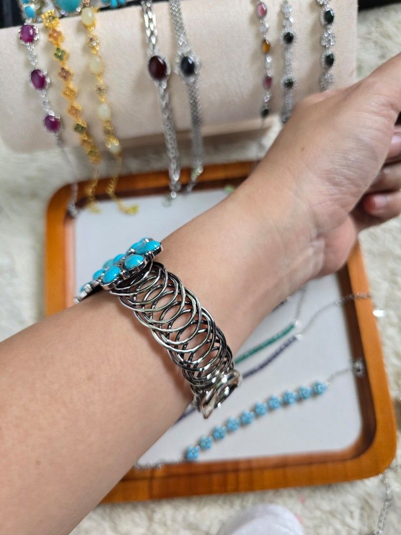 Turquoise Cuff Bracelet with Silver Tone Metal (Category: Bracelets) located in Santa Rosa. Submitted by crystal1.0 (Listing ID 1453759392, Image 3). Description: - Statement cuff bracelet - Features a large central turquoise stone - Accented with smaller turquoise stones - Intricate silver-toned metal design - Adjustable - Coiled metal band at the back - Unique piece for adding a pop of color to any outfit.