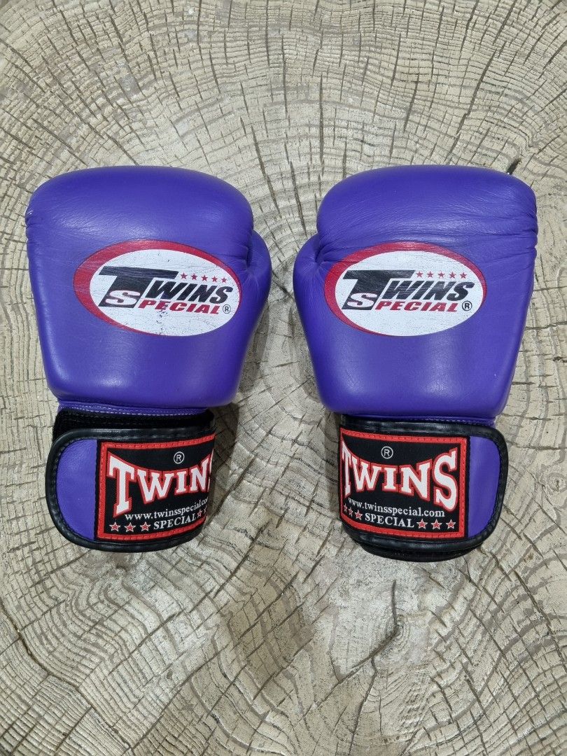 Twins Special Purple 8oz Boxing Gloves (Category: Combat Sports) located in Mandaue City. Submitted by john-e-collection (Listing ID 1453710595, Image 1). Description: - Authentic Twins Special boxing gloves - Color: Purple - Weight: 8 oz - Material: Genuine Leather - Origin: Made in Thailand - Ideal for: Training and sparring - Condition: Good, with minor scuffs from use - Closure: Velcro strap.