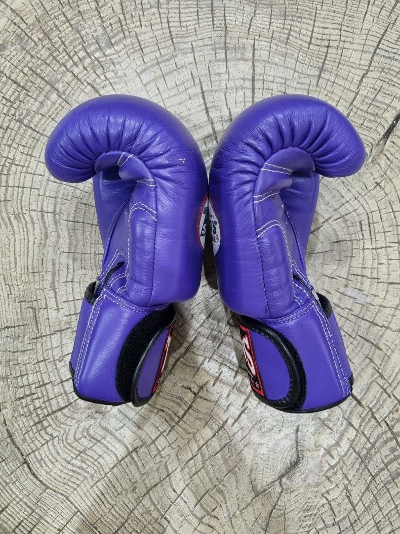 Twins Special Purple 8oz Boxing Gloves (Category: Combat Sports) located in Mandaue City. Submitted by john-e-collection (Listing ID 1453710595, Image 3). Description: - Authentic Twins Special boxing gloves - Color: Purple - Weight: 8 oz - Material: Genuine Leather - Origin: Made in Thailand - Ideal for: Training and sparring - Condition: Good, with minor scuffs from use - Closure: Velcro strap.
