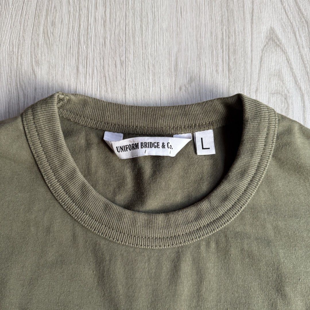 Uniform bridge & Co Embroidered Tee (Category: Tshirts & Polo Shirts ) located in Zamboanga. Submitted by rustic.rev (Listing ID 1453705955, Image 3). Description: Uniform bridge & Co Embroidered Tee In excellent condition, bleach stain last photo not visible when worn. Tagged: Large Measurements: Pit to pit: 22.5 inches Length: 28.5 inches Shoulders: 18.5 inches ₱690 + sf Dm or comment “mine” to purchase 📩.