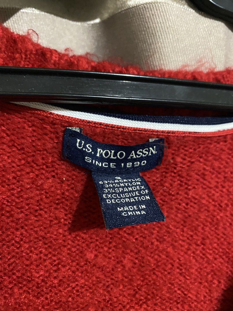 US Polo Assn. Red Cable Knit V-Neck Sweater (Category: Coats, Jackets and Outerwear) located in San Pedro. Submitted by kc_cccc1 (Listing ID 1453748131, Image 2). Description: - US Polo Assn. red cable knit sweater - V-neck design - Signature polo player logo on chest - Material: Acrylic, Nylon, Spandex blend - Perfect for layering or wearing on its own - Comfortable and stylish.