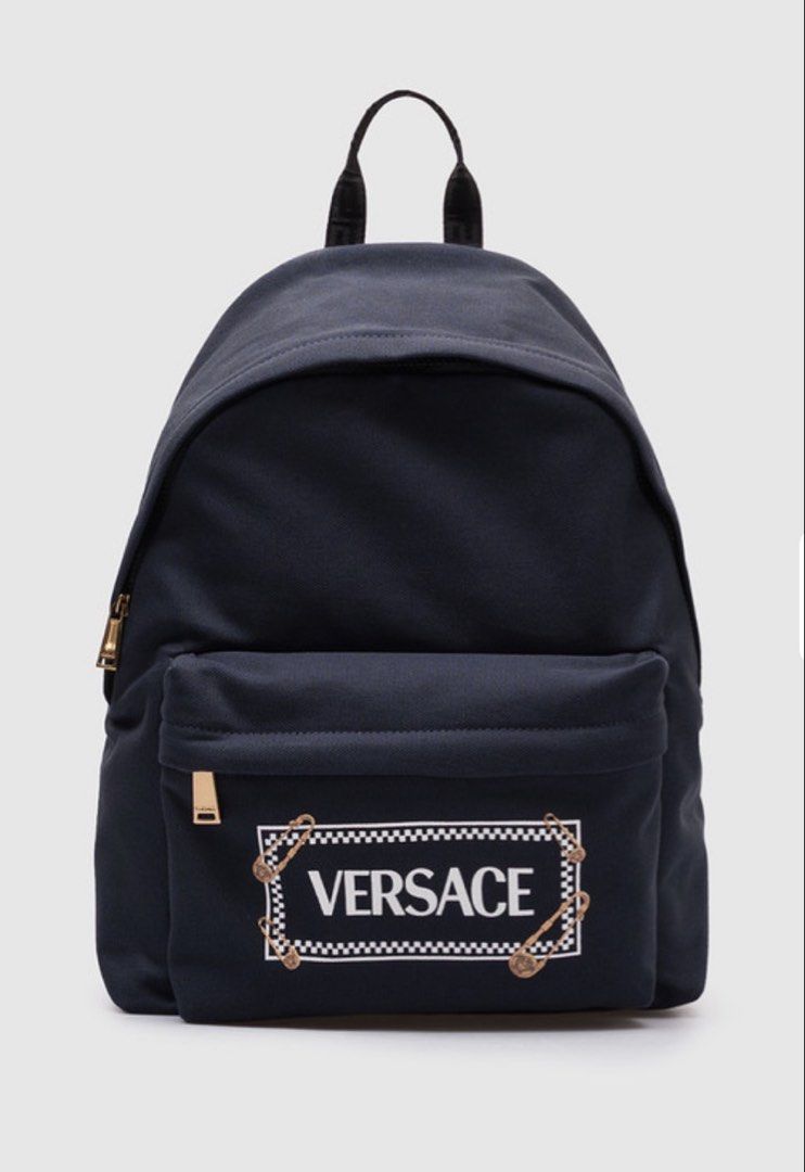 Versace Backpack (Category: Bags & Wallets) located in Singapore. Submitted by larashan (Listing ID 1453788515, Image 2). Description: Versace Safety Pin Logo Backpack – BNIB Brand new in box, never used. Got it as a gift 🎁 * Authentic Versace * Original retail price : SGD $900 * Generous size that can be worn by teens and adults too * Size: 29.5 × 20 × 40 cm * Material: Cotton canvas with calf leather trim * Safety Pin Logo Backpack * Style: 10