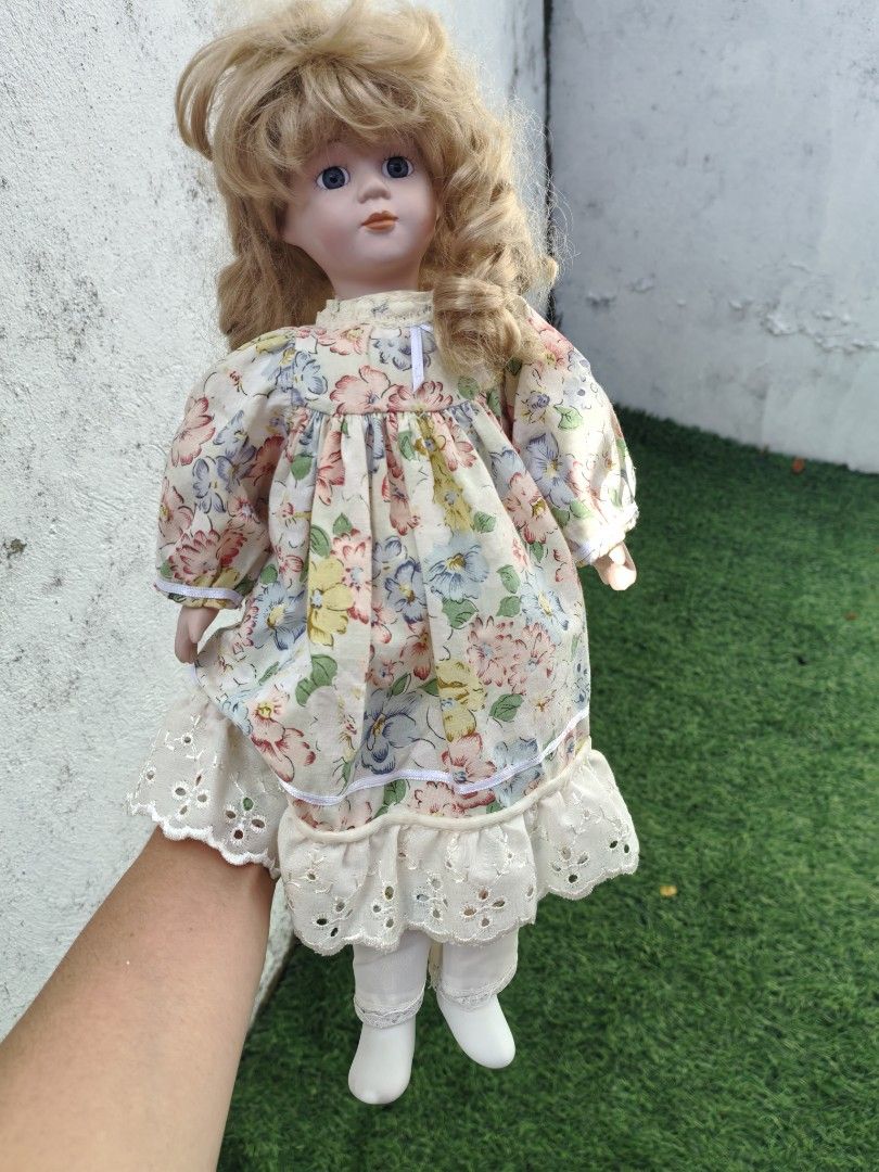 Vintage Porcelain Doll (Category: Vintage Collectibles) located in Cebu City. Submitted by dudes_villanueva (Listing ID 1453670396, Image 1). Description: Vintage Porcelain Doll 📌 a popular type of collectible hobby toy manufactured widely between the 1980s and late 1990s. 📌 Crafted with a bisque porcelain (ceramic) head, hands, and lower legs, attached to a soft, stuffed fabric body 📌 Features blonde hair styled with bangs, blue glass inset e