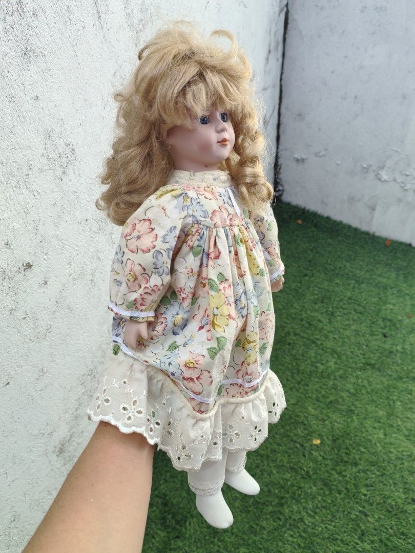 Vintage Porcelain Doll (Category: Vintage Collectibles) located in Cebu City. Submitted by dudes_villanueva (Listing ID 1453670396, Image 3). Description: Vintage Porcelain Doll 📌 a popular type of collectible hobby toy manufactured widely between the 1980s and late 1990s. 📌 Crafted with a bisque porcelain (ceramic) head, hands, and lower legs, attached to a soft, stuffed fabric body 📌 Features blonde hair styled with bangs, blue glass inset e