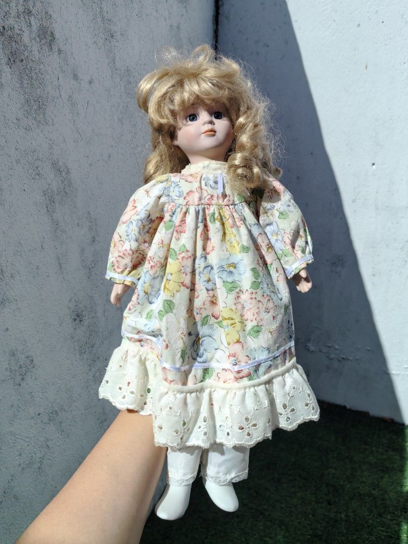 Vintage Porcelain Doll (Category: Vintage Collectibles) located in Cebu City. Submitted by dudes_villanueva (Listing ID 1453670396, Image 2). Description: Vintage Porcelain Doll 📌 a popular type of collectible hobby toy manufactured widely between the 1980s and late 1990s. 📌 Crafted with a bisque porcelain (ceramic) head, hands, and lower legs, attached to a soft, stuffed fabric body 📌 Features blonde hair styled with bangs, blue glass inset e