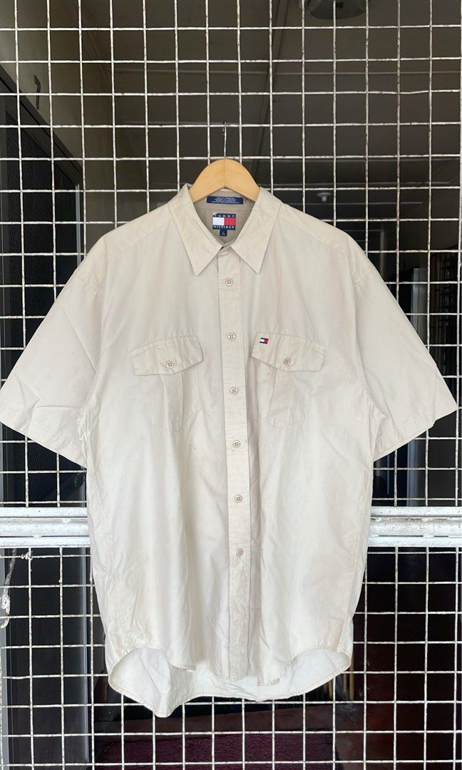 Vintage Tommy Hilfiger cream short-sleeve button-down (Category: Formal Shirts) located in Marikina City. Submitted by 4af966271c192b2f74291393ce6f74 (Listing ID 1453687038, Image 1). Description: Vintage Tommy Hilfiger cream short-sleeve button-down utility shirt featuring dual chest flap pockets and the brand’s classic embroidered flag logo on the left pocket. .